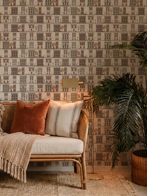 Vintage city wallpaper with illustrated European townhouses, lamps, bicycles, benches and orange-gold trees