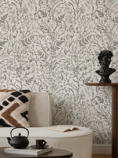 Black outline botanical wallpaper with charcoal wildflowers and grasses on a warm ivory cream ground