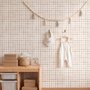 Soft brown wallpaper with pale beige gingham checks on a warm cream off-white ground