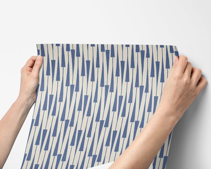 Cream colored wallpaper with denim blue geometric totem stripe repeat on a linen texture ground
