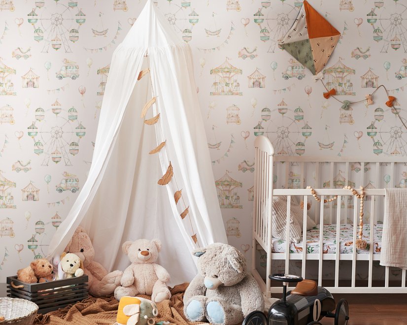 Children's playroom wallpaper with pastel Ferris wheel, carousel horses, tents and balloons on blush pink
