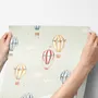 Watercolor blue wallpaper with hot air balloons, cream clouds and peach stars on pale sage green