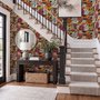 Floral and fish wallpaper with coral blooms, teal fish and black white flowers on metallic mustard-gold ground