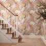 Pink tropical wallpaper with ivory fan palms, orchids, coral blossoms and sage foliage on dusty rose