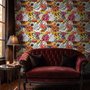 Floral and fish wallpaper with coral blooms, teal fish and black white flowers on metallic mustard-gold ground