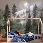 Misty mountain wallpaper mural with tall pine trees, layered green forest and pale foggy ridges