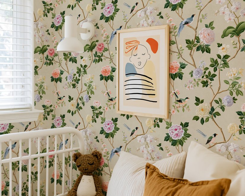 Chinoiserie wallpaper with blue-grey birds, pink peonies, white orchids and green branches on ivory-cream ground