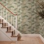 Vintage bamboo wallpaper with sage and smoky blue-green leaves on a warm taupe ground