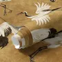 Japanese crane wallpaper with white, black and red cranes in flight on an antique-gold textured ground