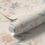 Pink chinoiserie wallpaper with watercolor flowers, blue-grey leaves and red berries on a cream linen-texture ground