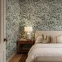 Sage green botanical floral wallpaper with white poppy flowers, lobed leaves and dotted seed centres