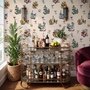 Bar area wallpaper with hand drawn cocktails, liquor bottles, citrus and fruit bowls on warm cream