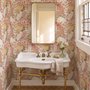 Pink tropical wallpaper with ivory fan palms, orchids, coral blossoms and sage foliage on dusty rose