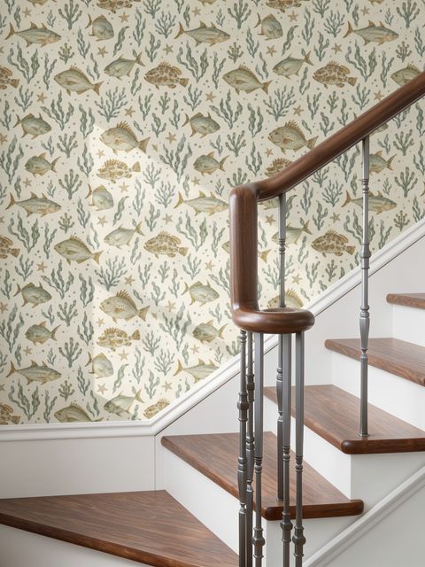 Watercolour fish wallpaper with sage seaweed, coral and starfish on a warm cream background