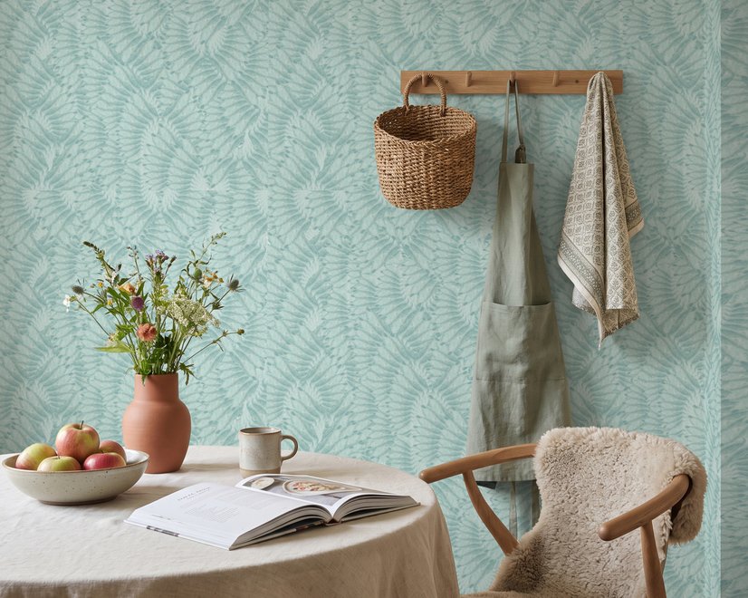 Aqua fern wallpaper with overlapping icy blue palm fronds on a pale aqua ground
