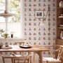 Bar wallpaper with cream tile grid, dusty rose arches, illustrated wine bottles, fruit and café still lifes