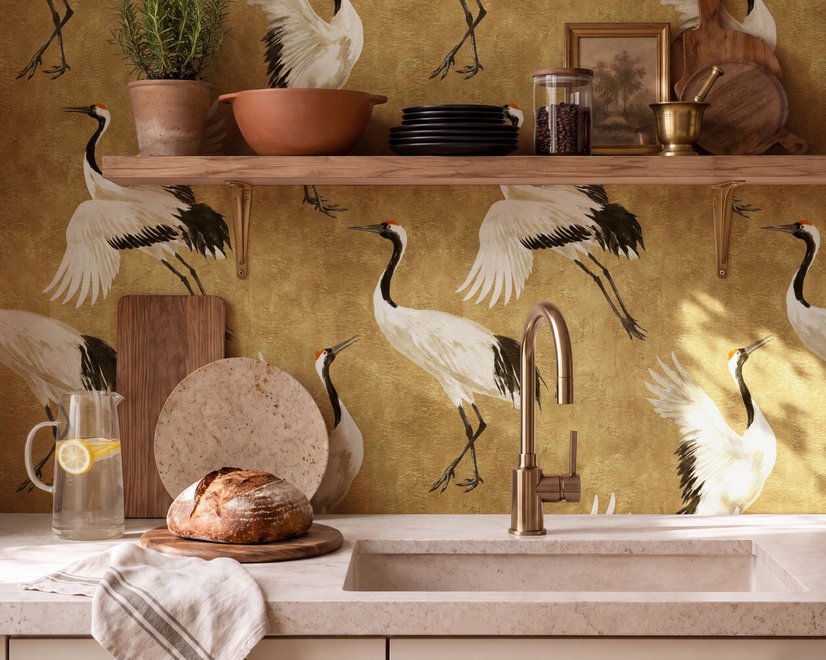 Japanese crane wallpaper with white, black and red cranes in flight on an antique-gold textured ground