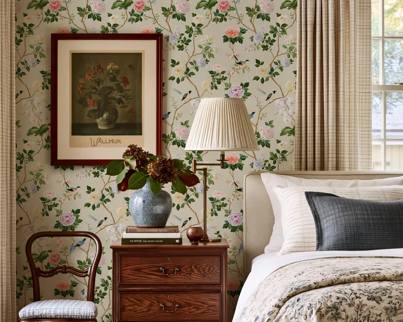 Chinoiserie wallpaper with blue-grey birds, pink peonies, white orchids and green branches on ivory-cream ground