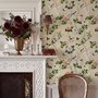 Chinoiserie wallpaper with blue-grey birds, pink peonies, white orchids and green branches on ivory-cream ground