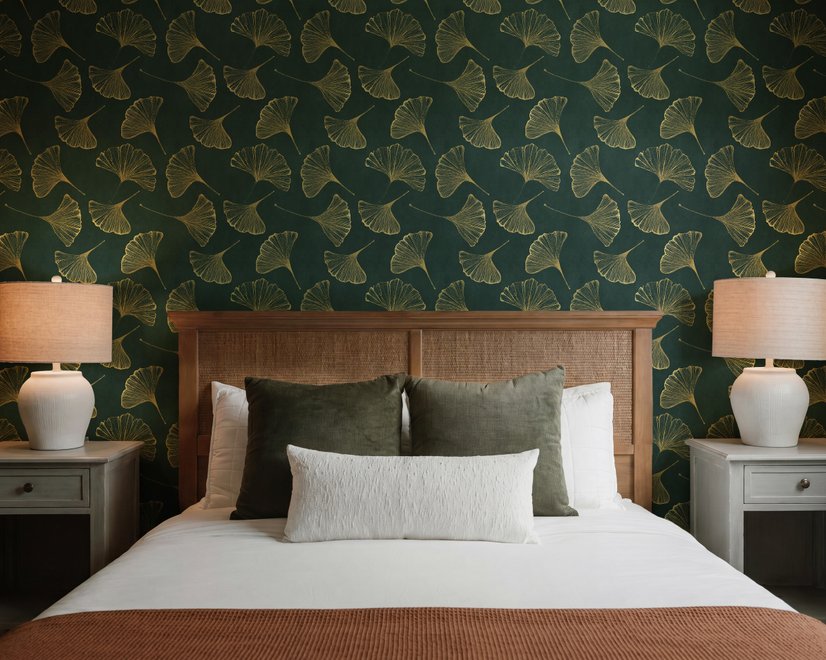 Dark green wallpaper with metallic antique-gold etched ginkgo leaves on a textured forest-green teal ground