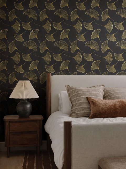 Black wallpaper with antique metallic gold ginkgo leaves on a mottled charcoal ground