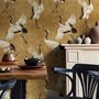 Japanese crane wallpaper with white, black and red cranes in flight on an antique-gold textured ground
