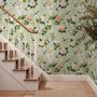 Celadon-sage chinoiserie wallpaper with blue-grey birds, tan branches, pink peonies and white orchids