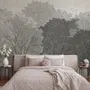 Light gray wallpaper mural with layered ink-wash woodland trees, falling leaves and birds