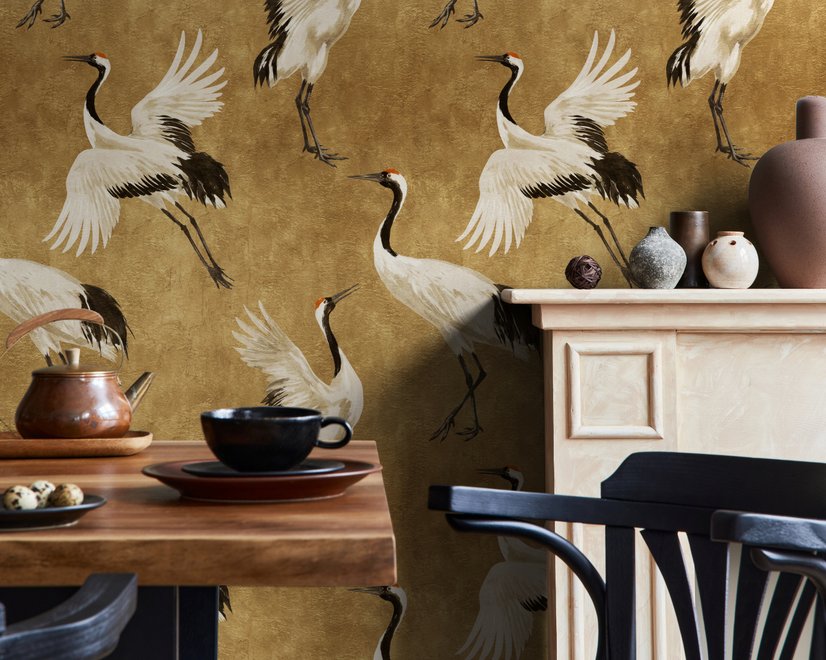 Japanese crane wallpaper with white, black and red cranes in flight on an antique-gold textured ground
