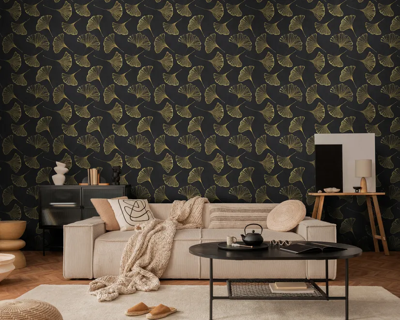 Black wallpaper with antique metallic gold ginkgo leaves on a mottled charcoal ground