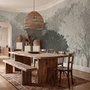 Light gray wallpaper mural with layered ink-wash woodland trees, falling leaves and birds
