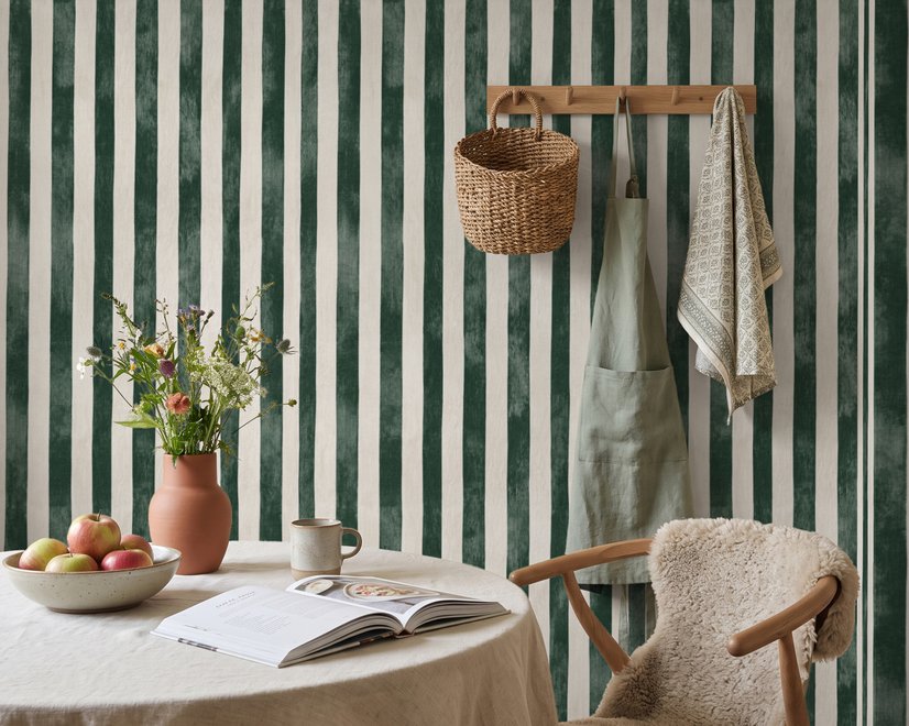 Green striped minimalist wallpaper with vertical deep forest green bands on a soft warm ivory ground.