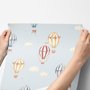 Hot air balloon wallpaper with watercolor balloons, ivory clouds and peach gold stars on pale powder blue