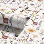Cute spring wallpaper with pressed ivory, pink, blue and yellow wildflowers on a white ground