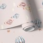 Hot air balloon nursery room wallpaper with watercolour balloons, clouds and stars on a soft blush-pink ground