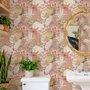 Pink tropical wallpaper with ivory fan palms, orchids, coral blossoms and sage foliage on dusty rose