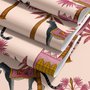 Tropical foliage wallpaper with black panthers, pink palace facades and ochre palms on pale peach