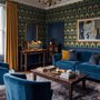 Art Deco feathers wallpaper with turquoise peacock eyes, gold plumes and navy teal ground