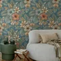 Blue tropical wallpaper with hibiscus, orchids, lilies, monstera leaves and palm fronds on a deep teal-blue ground