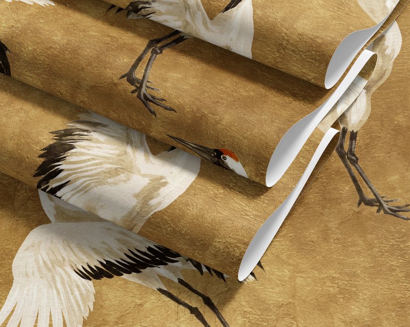 Japanese crane wallpaper with white, black and red cranes in flight on an antique-gold textured ground