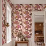 Tropical foliage wallpaper with black panthers, pink palace facades and ochre palms on pale peach