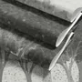 Light gray wallpaper mural with layered ink-wash woodland trees, falling leaves and birds
