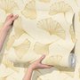 Ginkgo leaf wallpaper with ochre-gold linework on warm ivory and cream parchment ground