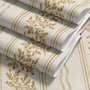 Gold and white wallpaper with antique gold leafy sprig stripes on parchment cream