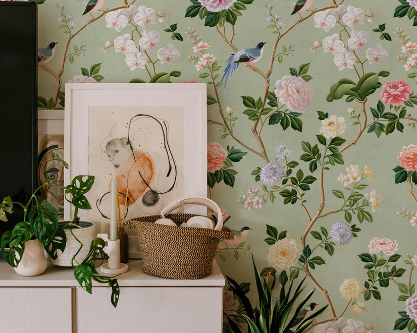 Celadon-sage chinoiserie wallpaper with blue-grey birds, tan branches, pink peonies and white orchids