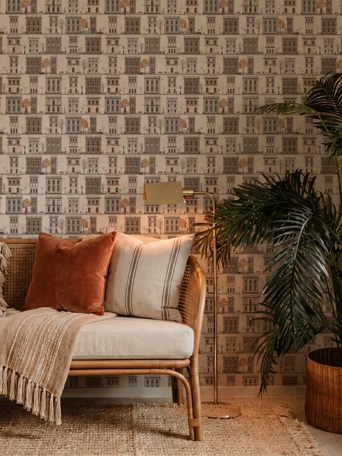Vintage city wallpaper with illustrated European townhouses, lamps, bicycles, benches and orange-gold trees