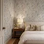 Watercolour wildflower wallpaper with pastel flowers and sage leaves on a white ground
