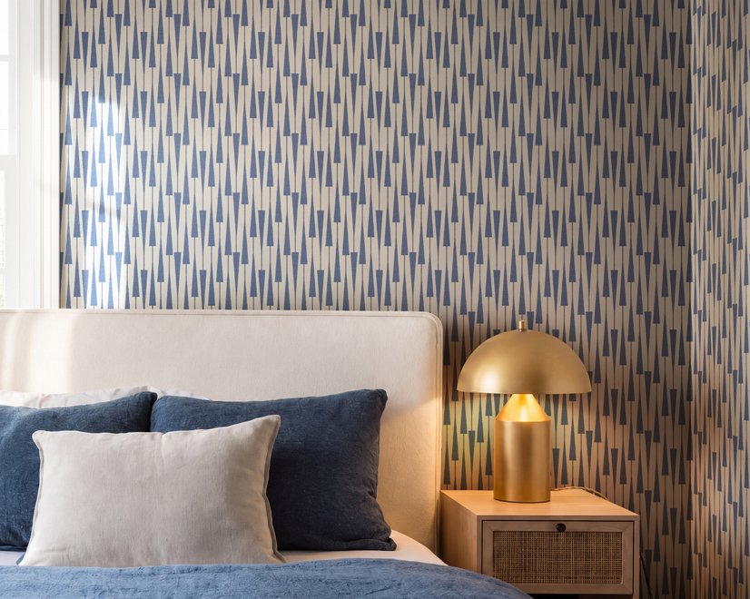 Cream colored wallpaper with denim blue geometric totem stripe repeat on a linen texture ground