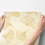 Ginkgo leaf wallpaper with ochre-gold linework on warm ivory and cream parchment ground