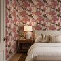 Tropical foliage wallpaper with black panthers, pink palace facades and ochre palms on pale peach